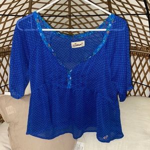 Blue Hollister blouse with floral trim